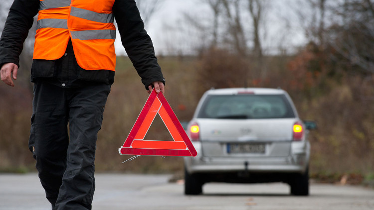 Vorbildlich: Bei einer Panne Warndreieck aufstellen und Warnweste tragen. Obwohl Letzteres in Deutschland keine Pflicht ist. Man muss sie aber im Wagen dabei haben.